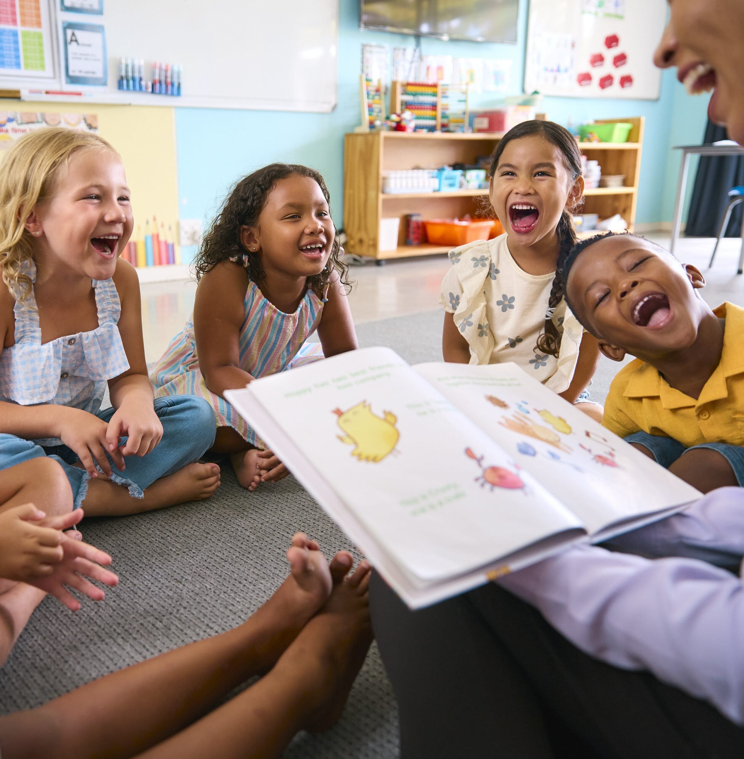 Children laughing during storytime in a classroom